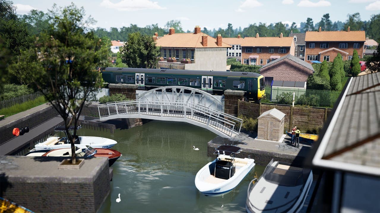 A green GWR Class 165 passing behind a white footbridge over a small river harbour with motorboats in Train Sim World